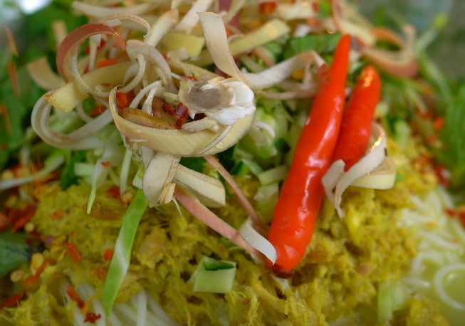 A plate of colorful vegetables, including vibrant red peppers, arranged appetizingly